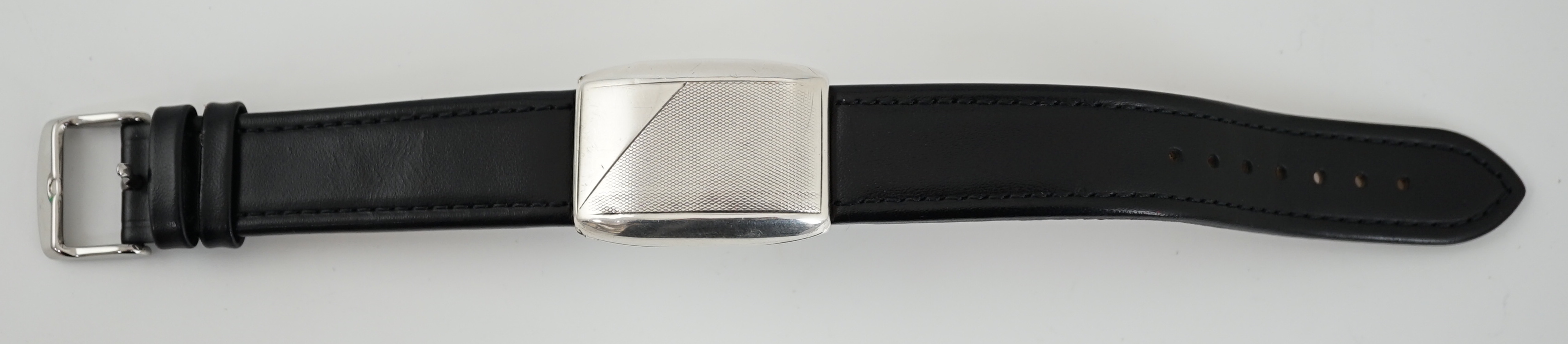 A gentleman's late 1920's silver flip action manual wind rectangular wrist watch